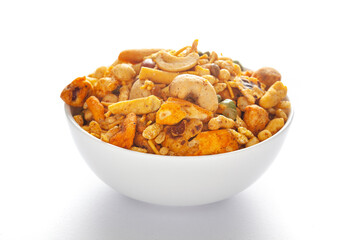 Pile of Indian spicy snacks (Namkeen) - 'All in one' in a white bowl, made with fried peanut, corn...