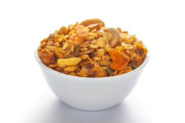 Pile of Indian spicy snacks (Namkeen) - 'All in one' in a white bowl, made with fried peanut, corn...