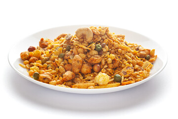 Pile of Indian spicy snacks (Namkeen) - 'All in one' in a white plate, made with fried peanut, corn flakes, sweet pea, pulses, cashew nuts, etc. side view, against the white background.