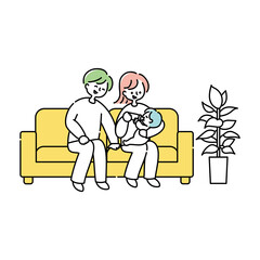 ソファーで赤ちゃんにミルクを飲ませる夫婦