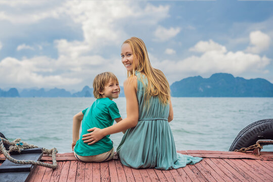 Mom and son travelers is traveling by boat in Halong Bay. Vietnam. Travel to Asia, happiness emotion, summer holiday concept. Traveling with children concept. After COVID 19. Picturesque sea landscape