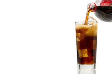 Pouring Cola to glass with ice cubes isolated on white