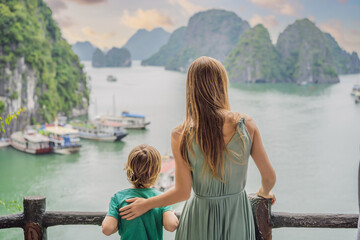 Fototapeta premium Mom and son travelers in Halong Bay. Vietnam. Travel to Asia, happiness emotion, summer holiday concept. Picturesque sea landscape. Ha Long Bay, Vietnam. After coronavirus COVID 19