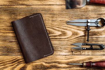 handmade leather wallet with tools from the workshop. genuine leather accessory