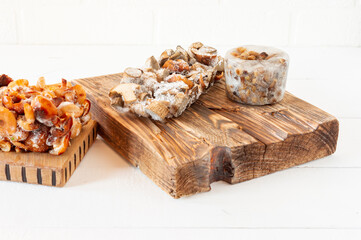 Semi-finished products. Frozen food. Agaric of honey mushrooms on cutting board.