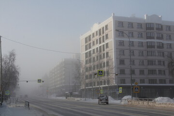 Streets of Khanty-Mansiysk city in Russia in severe frost and fog. At minus 45 degrees the streets are drowning in fog.