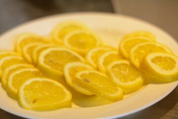Juicy Lemon In Thin Slices Served On Plate