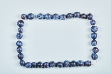 Group of fresh plums on a blue background
