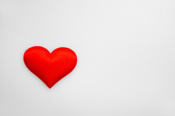 One single textured red heart on top of each other on a white or gray background: place for text, St. Valentine's Day background, minimalism 