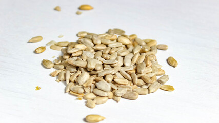 Peeled sunflower seeds on a white background. Energy supply of the body.