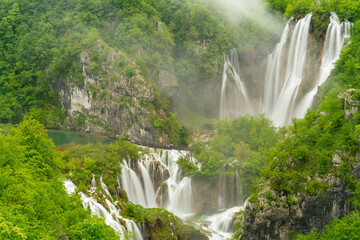 long exposure shot of veliki slap, the largest waterfall at plitvice, at on a rainy misty day at plitvice lakes national park © chris
