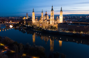 Fototapeta na wymiar Night aerial view of Zaragoza with Cathedral-Basilica of Our Lady of Pillar on bank of Ebro river, Spain