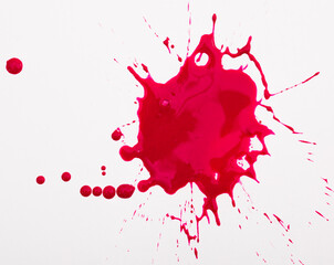 Fototapeta na wymiar Splash and splatters of spilled paint of red color on white surface..