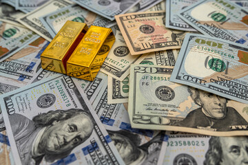 gold bar on 100 dollar bills