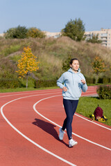 Obraz premium Training on the street, a young female athlete makes a workout on the street platform.