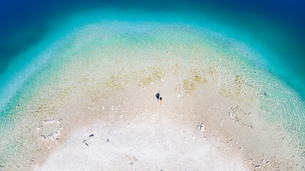 Person walking in a beautiful lake in Slovenia. Bohinj Lake