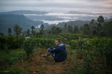 Tourist in the mountains against the background of fog.