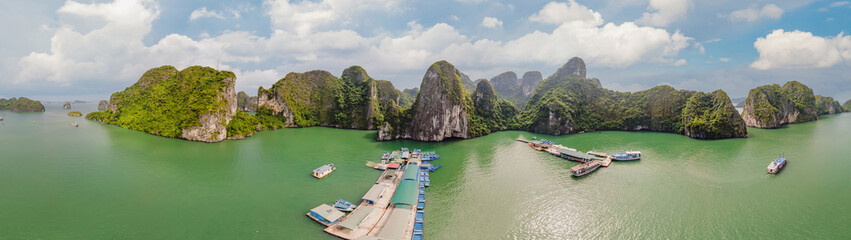 Aerial view panorama of floating fishing village and rock island, Halong Bay, Vietnam, Southeast Asia. UNESCO World Heritage Site. Junk boat cruise to Ha Long Bay. Popular landmark of Vietnam © galitskaya