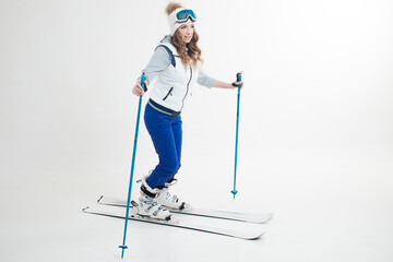 young woman goes skiing. Skier maneuvers on mountain skis, photos on a white background in the Studio,