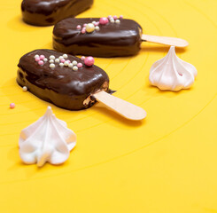 Marshmallow on a popsicle stick covered in chocolate with pink meringue. Selective focus.