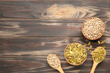 Healthy superfood: sesame, pumpkin seeds, sunflower seeds, flax seeds and chia on brown. Seeds on spoon.