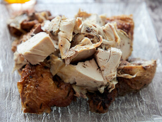 grilled chicken dish cut into large chunks laid out on a plate