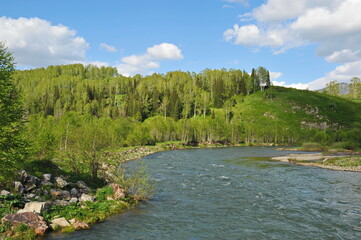 Ridder, Kazakhstan - 06.05.2013 : The Irtysh River, which flows along a mountainous and hilly area with different vegetation.