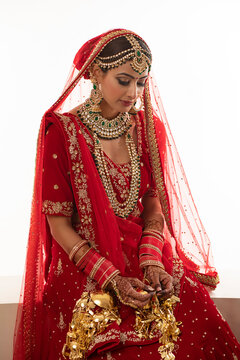 Indian bride wearing traditional Indian jewellery sitting down	