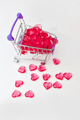 Valentine's day, endless love or special occasion concept : Top view of red hearts spilled out of a shopping cart. isolated on white background. copy space.