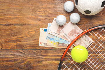 Money and balls on wooden background. Concept of sports bet