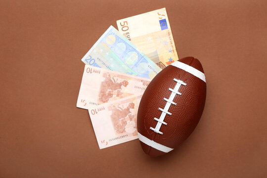 Money and rugby ball on color background. Concept of sports bet