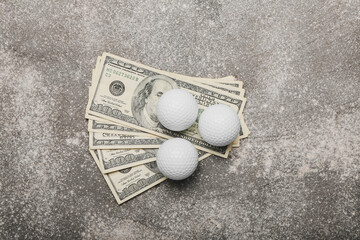 Money and golf balls on grunge background. Concept of sports bet