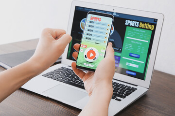 Man placing sports bet at home