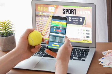 Man placing sports bet at home