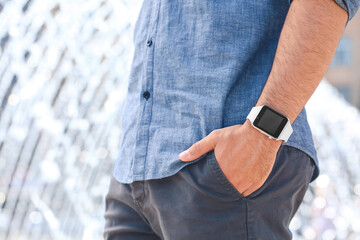 Young man with modern wristwatch outdoors