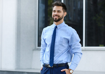 Handsome businessman with stylish wristwatch outdoors