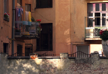 Fototapeta na wymiar Small cozy courtyard, colorful linen drying on the balcony