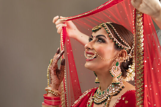 Veil being put on an Indian bride 	