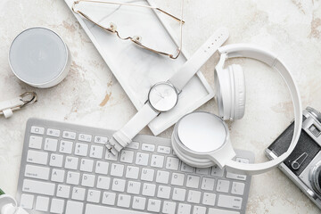 Stylish composition with wristwatch, gadgets and glasses on light background