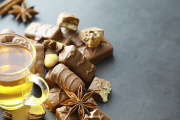 Chocolate bars on a black background in backlight. Chocolate with filling. Sweet sweets for snack and tea.