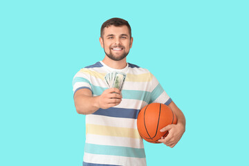 Young man with money and ball on color background. Concept of sports bet