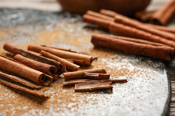 Cinnamon sticks and powder on table