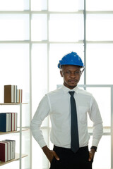 Portrait of African American engineer men wearing helmets and formal white shirts at the office.