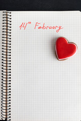 Notepad Reminder: February 14. Valentine's day, place for text. Small red cookie