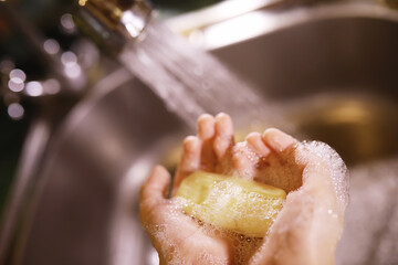 Fototapeta premium Hygiene rules. Hand washing before meals. Antibacterial treatment of hands with soap. A way to prevent virus infection. Coronavirus protection.