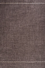 Textile surface. Brown fabric background. Vertical frame