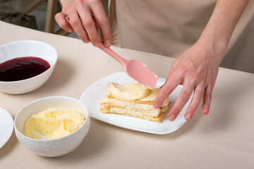 Obraz na płótnie Canvas Process of making cake with vanilla cream and jam. Pastry chef preparing pie