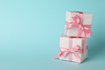 Gift boxes on blue background, space for text