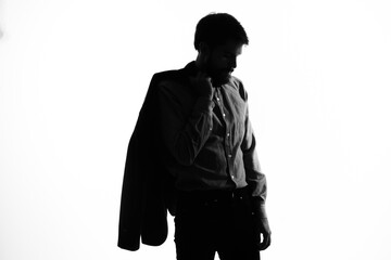 man in a suit holding a jacket in his hands emotions profile silhouette shadow