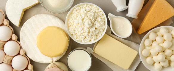 Different fresh dairy products on gray background, top view
